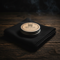 Black Powder Beard Butter on gray weathered wood with black linen and smoke